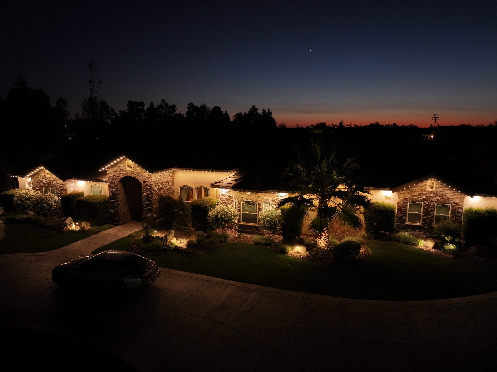 Luxury estate at dusk illuminated with bluEmber permanent outdoor lighting