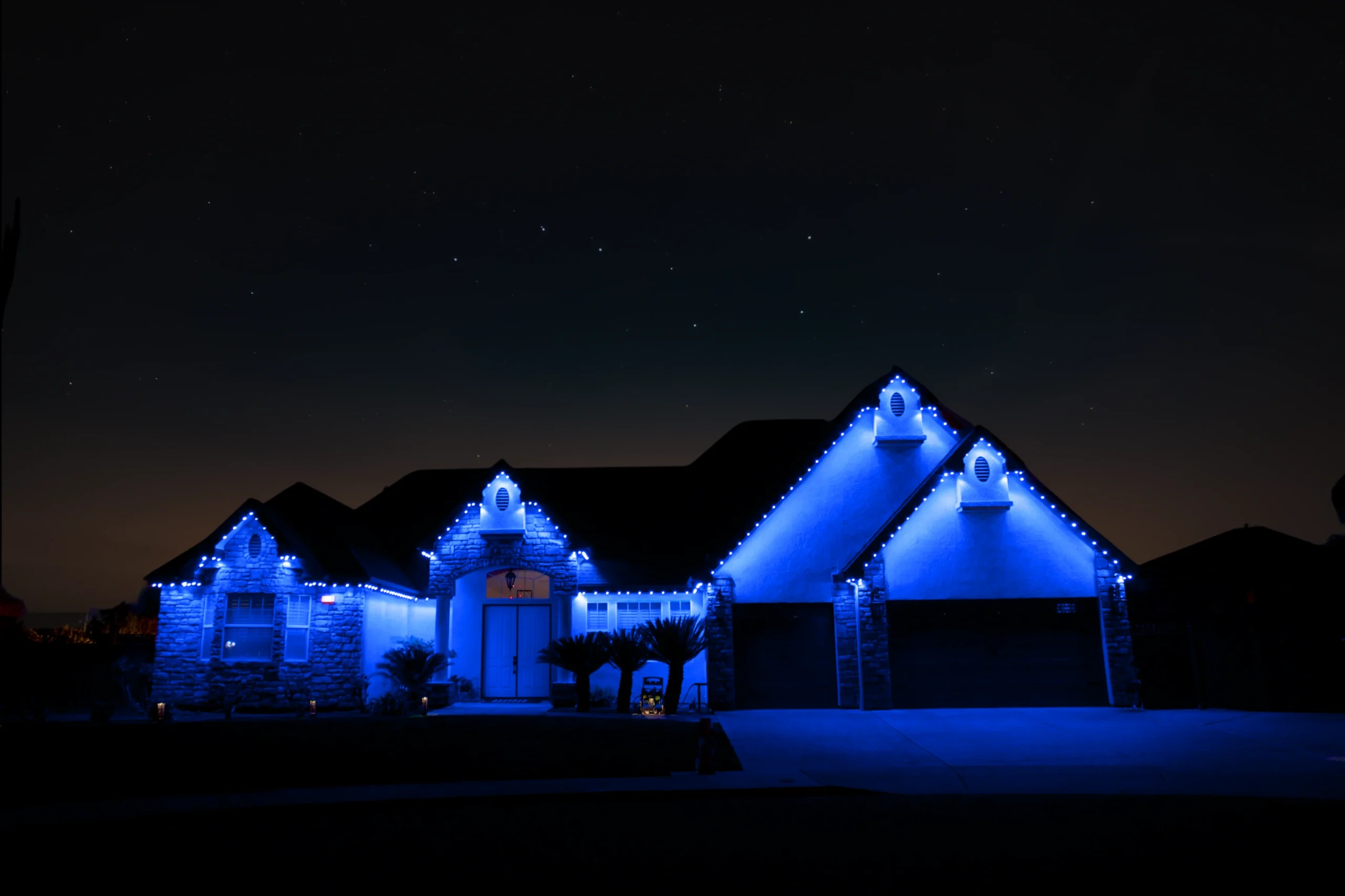 bluEmber Lights illuminating a home at night